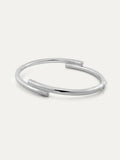 A polished silver open cuff bracelet with a modern design and with engraved Chinese character 心, displayed on a clean off-white background.