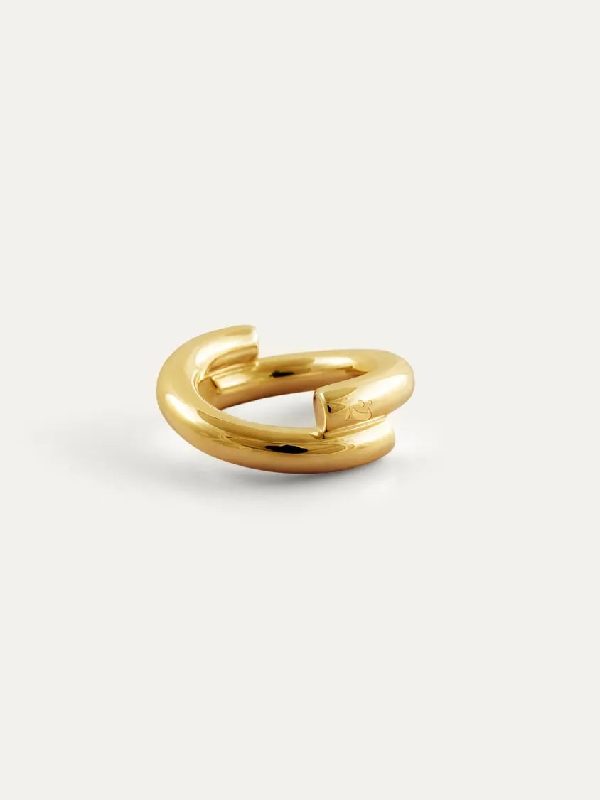 A polished 18k gold vermeil ring with a unique open, curved design and engraved Chinese character 心, displayed on a clean off-white background.